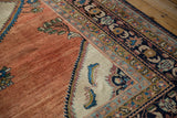 Vintage Persian Lilihan corner showing the ivory spandrel against an abrashed copper-rose field.