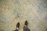 The soft, time-worn texture of a vintage Meshed carpet in dusty blue, cream, and rust.