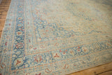 Intricate sky blue border with rust botehs on the worn corner of a vintage distressed carpet.