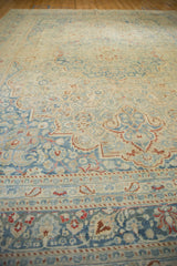 Low angle view of the intricate distressed surface on a vintage Persian Meshed carpet.
