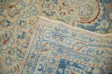 Lifted corner of a vintage Meshed carpet reveals the hand-knotted construction.