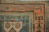 Worn knots and visible foundation on the asymmetric border of a vintage distressed Bijar rug.