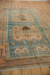 Angled view of a distressed Bijar runner, highlighting the time-softened texture and primitive design motifs.