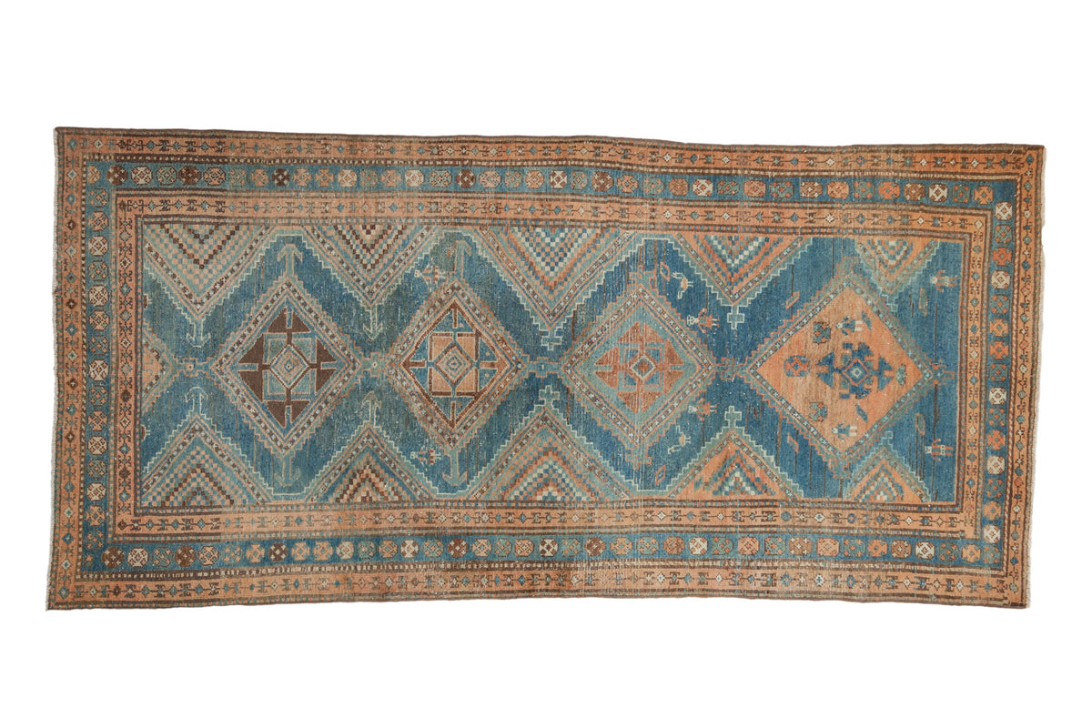 Distressed Persian Malayer runner with a column of geometric diamond medallions in sky blue and pale coffee brown.