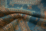Distressed hand-knotted texture of a vintage Malayer rug with visible bird motifs in sky blue and coffee brown.