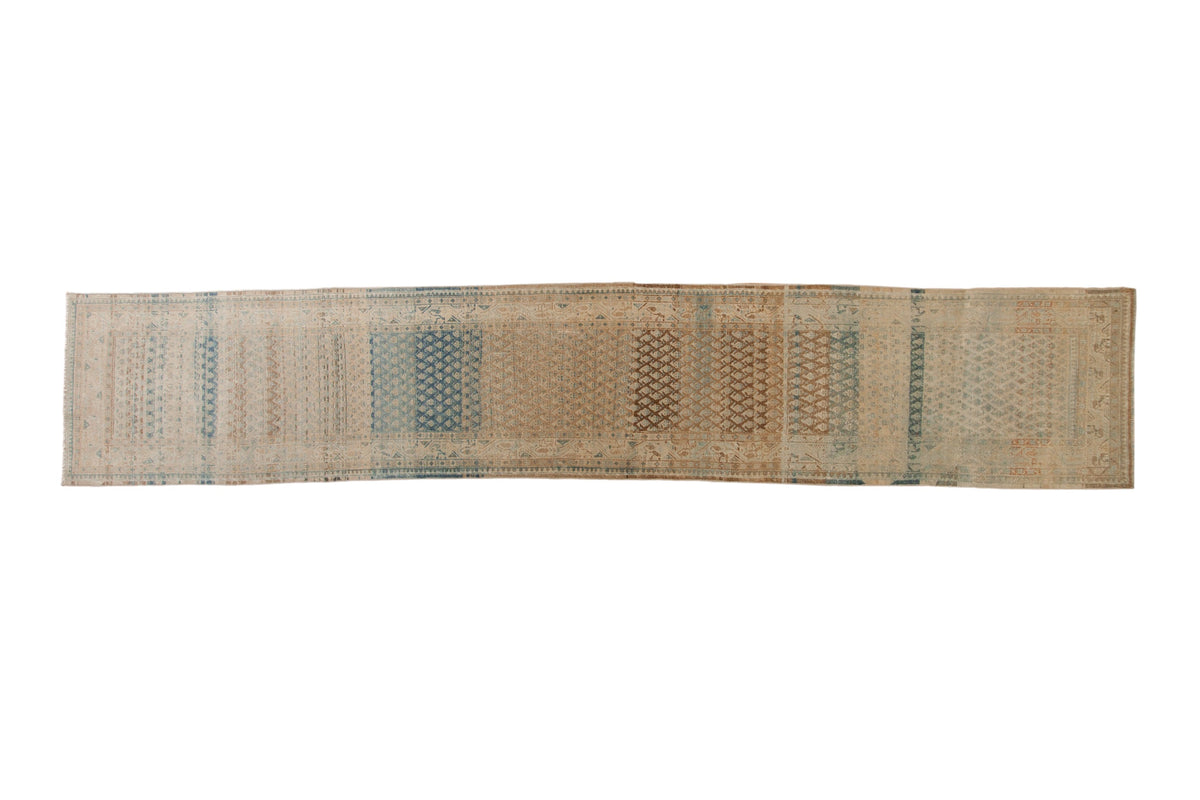 Distressed Mir Sarouk runner with a repeating boteh design and heavy color striations in brown, blue, and ivory.