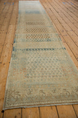Angled view down the distressed Persian runner emphasizes its heavy abrash and varied dye lots.