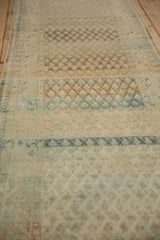 Heavy abrashes showing striations of dusty blue and pale coffee brown on the distressed runner.