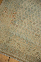 Detail of the worn, low pile and staggered boteh pattern on a vintage Persian runner.