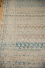 View down the vintage Sarouk runner showing the worn pile and machine-bound side.
