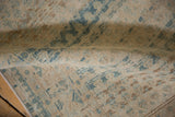 A gentle fold in the distressed vintage runner highlights the low, hand-knotted pile.