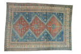 Distressed vintage Caucasian rug with triple ruby red pomegranate medallions on a sky blue field.