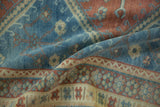 Detailed view of the vintage Caucasian rug's even wear and soft, low-pile texture.