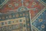 A folded corner on a vintage Caucasian rug reveals its back weave and secure machine-bound side.