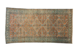 Antique Persian Malayer carpet with a geometric diamond lattice pattern in dusty rose, terracotta, and powder blue.