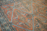 Textured, low pile of an antique Malayer carpet showing detailed Herati-like motifs in terracotta and blue.
