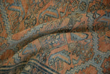 Textured knot-head pile of a distressed Malayer carpet with geometric patterns in terracotta and dusty blue.