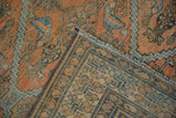 The hand-knotted back and distressed front pile of an antique Malayer carpet's folded corner.