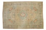 Vintage distressed Tabriz carpet with a central medallion and boteh field in slate blue, cream, and cinnabar red.