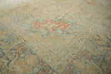 Softly worn corner of a vintage Persian Tabriz with slate blue and cinnabar red vines.