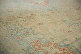Angled view of the vintage Tabriz carpet showing its mostly even wear and low pile.