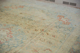 The soft texture and even wear of a vintage distressed Tabriz carpet with a pale blue and cinnabar red palette.