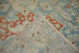 Folded corner of a vintage Tabriz carpet revealing the pile and hand-knotted back.