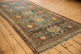 Angled view along the distressed Mehreban runner, highlighting the traditional boteh border motifs.