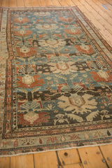 Angled view down the length of a distressed Mehreban runner in dusty teal and chestnut hues.