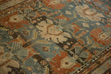 Heavy abrashes and low pile texture across the palmette design of a distressed Mehreban rug.