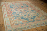 Vintage distressed Malayer rug featuring soft blue, red, and ivory abrashed geometric patterns.