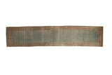 Distressed vintage Hamadan runner with repeating botehs on a dusty blue field and sand-colored borders.