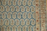 Distressed low-pile weave of a Persian Hamadan rug with sand and blue boteh motifs.