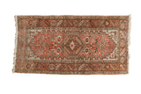 Vintage distressed Heriz rug with a hexagonal medallion and geometric patterns in dusty blush and silver.