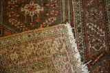 Knot heads and foundation visible on the back of a distressed hand-knotted Persian rug.