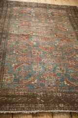 Distressed vintage Malayer rug close-up with worn pile, dusty teal, and madder red tones.
