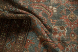 Distressed Malayer rug pile detail, showing madder red, dusty teal, and exposed knot heads.