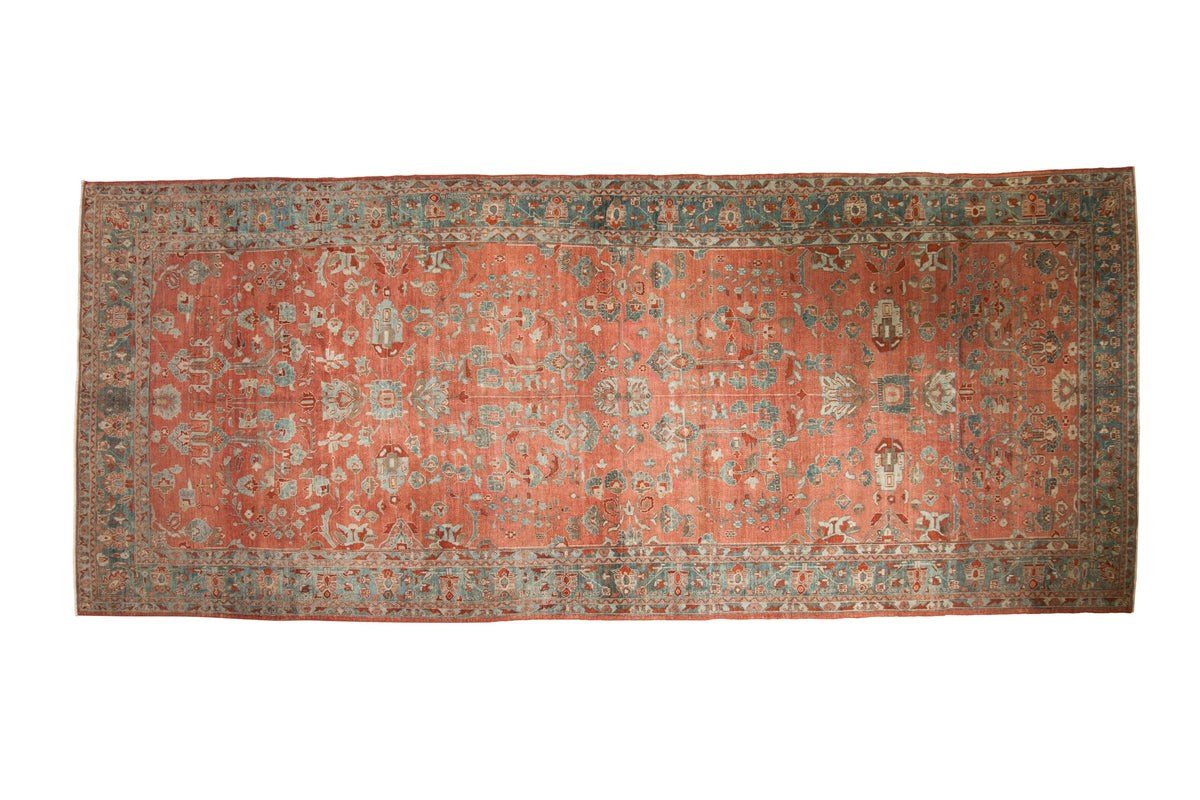 Vintage distressed Persian Bibikabad runner with an allover floral pattern in ruby red and dusty teal.