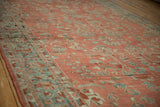Time-softened dusty teal and blush tones on the low-pile of a vintage Bibikabad carpet.
