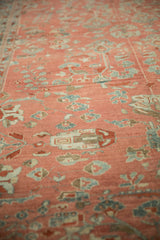 Low pile texture and even wear on a vintage Bibikabad rug with blush and dusty teal motifs.