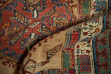 The soft, folded pile of a vintage Serab rug highlights its geometric pawn borders.