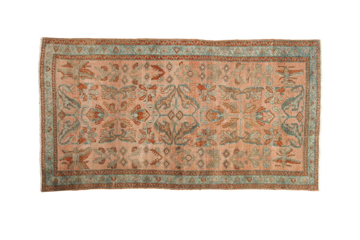 Vintage Distressed Lilihan rug with sprawling floral arabesques in dusty blush, teal, and rust tones.