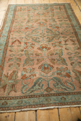 Angled perspective highlighting the sprawling floral design on a distressed vintage Lilihan rug.