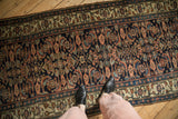 Detailed Herati design in dusty rose and blue on the deep indigo field of a 1920s Bijar runner.