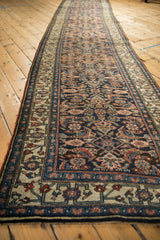 Long perspective view of the antique Bijar runner's allover Herati design and geometric main border.