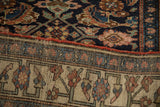 The antique Bijar's dense wool pile contrasted with its intricate hand-knotted foundation.