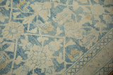 Close-up showing the worn pile and visible knot heads of a distressed blue and ivory Hamadan rug.