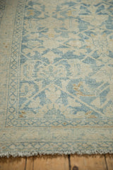 Detail of the worn, low pile and seed border on a vintage distressed Hamadan rug.