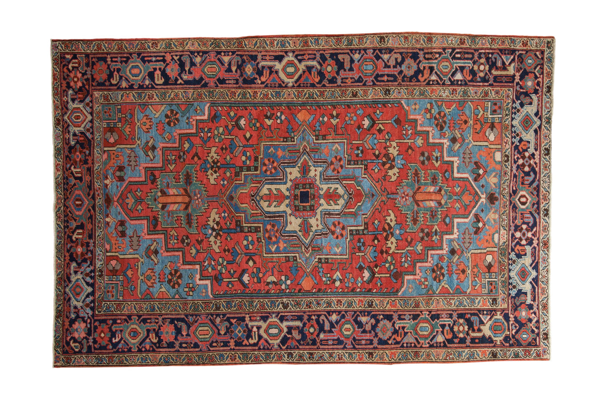 Antique Heriz carpet with red field, blue and green geometric patterns, navy border, 5'11