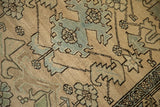 Low-pile texture of a distressed Heriz runner with powder blue and charcoal geometric motifs.